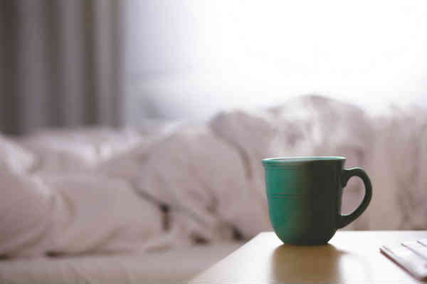 coffee cup next to bed