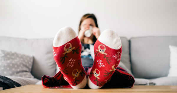 woman procastinating in her bed drinking coffee